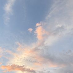 an airplane is flying high in the sky at sunset or sunrise with pink clouds and blue skies