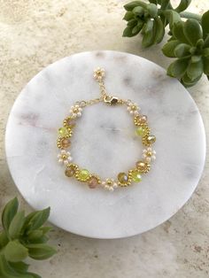 Meet our handmade Daisy Flower Bracelet in yellow ombre, with an elegant gold finish. It makes a great gift for many occasions such as birthdays, anniversaries, Christmas and more! Silver finish is also available in our shop. It is an adjustable bracelet from 6 inch to 7.5 inches in length which should fit most people comfortably. If you are looking for a specific length, please message us as we would love to make it for you! This fully handmade floral-themed bracelet features intricate designs Adjustable Yellow Gold Beaded Bracelet For Party, Elegant Yellow Beaded Bracelets With Gold Beads, Elegant Yellow Beaded Bracelet With Gold Beads, Adjustable Handmade Gold Bracelet, Adjustable Yellow Bracelets For Gifts, Adjustable Yellow Bracelets As Gift, Elegant Yellow Flower Bracelets, Elegant Yellow Flower Bracelet, Handmade Gold Crystal Bracelet With Round Beads