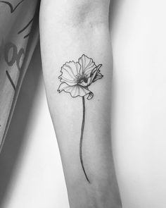 a black and white photo of a single flower on the left inner arm, with an arrow in the middle