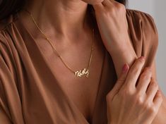 This delicate minimalist name necklace is a stylish option to carry your own name or the name of your loved ones. Crafted from 925 sterling silver and plated with 18K gold, ensuring long-lasting shine. Why this gift? Fast and high quality shipping Clear and reliable answers to all your questions, Solution-oriented customer services, High quality material and workmanship. Product Details: Material: 925 Sterling Silver Finish: 18K Gold Plated Chain Type: Snake Chain Chain Lenght : 12 Inches to 22 Inches Pendant: Custom Name Chain Length: Adjustable options available Packaging: Comes in a beautiful gift box, ready for gifting Customized Minimalist Pendant Name Necklace, Customized Minimalist Name Pendant Necklace, Minimalist Nameplate Necklace, Gold Minimalist Personalized Name Necklace, Everyday Nameplate Necklace, Everyday Nameplate Name Necklace, Elegant Everyday Engraved Name Necklace, Delicate Rose Gold Name Necklace, Minimalist Custom Name Necklace