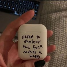 a person holding an airpods with writing on it