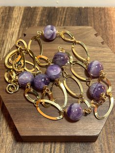 This is a beautiful, vintage, handmade, Italian genuine purple amethyst, 14K yellow gold overlay, and sterling silver necklace that was handmade in Italy. The necklace is about 30 inches. The necklace is just so gorgeous and features 8 round, polished, natural purple amethyst gemstones that are each 5/8" in diameter or 15.88mm. The amethyst is breathtaking shades of purple and each gemstone has a 14K yellow gold overlay cap on the ends. There are alternating large, open, oval links between the a Gold Amethyst Jewelry With Faceted Beads, Vintage Gold Amethyst Necklaces, Amethyst Oval Multi-stone Necklace, Vintage Multi-stone Amethyst Jewelry, Amethyst Multi-stone Dangle Jewelry, Southwestern Jewelry, Amethyst Necklace, Amethyst Gemstone, 14kt Gold