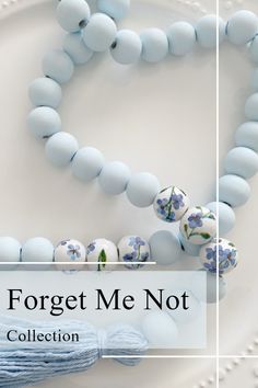 a white plate topped with blue beads next to a tasseled beaded necklace