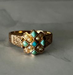 This is a antique Victorian ring in 10k rose gold. This ring has seed pearls and turquoise stones. Ring has initials VRF etched inside ring. Ring is in good condition with only age related wear. Ring is a size 7.5. Ring isn't marked 10k but was tested. Victorian Turquoise Jewelry For Anniversary, Turquoise Victorian Jewelry For Anniversary, Vintage Yellow Gold Turquoise Ring Hallmarked, Antique Yellow Gold Turquoise Ring For Anniversary, Vintage Yellow Gold Turquoise Ring For Anniversary, Antique Turquoise Ring For Anniversary, Vintage 14k Gold Turquoise Ring For Anniversary, Vintage Yellow Gold Turquoise Ring For Wedding, Vintage Yellow Gold Turquoise Wedding Ring