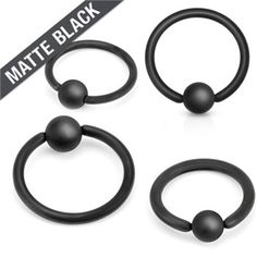 three pairs of black acrylic captive rings with balls on each one and a matte black ball in the middle