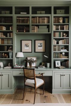 a home office with green walls and built in bookshelves is pictured here, along with a wicker chair