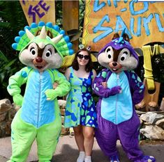 three people in costumes standing next to each other