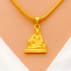 Make a statement with our Ethereal Sai Baba Pendant, crafted from 22k yellow gold and weighing 3.3 grams. With a delicate 1" length and intricate detailing, this pendant exudes a sense of grace and elegance. Elevate any outfit with this fashion-forward accessory that captures the essence of luxury and sophistication. PRODUCT DETAILS Gold Purity(karat): 22k Gold Weight(grams): 3.3 Item Finish: Yellow Gold Pendant Length: 1" Chain: Not Included PND22685W Festive Gold Locket Jewelry, Gold Temple Necklace With Locket For Wedding, Gold Locket Temple Necklace For Weddings, Gold Locket Jewelry For Diwali, Festive Gold Temple Necklace With Locket, Gold Pendant Temple Necklace For Diwali, Elegant Gold Temple Necklace For Puja, Festive Gold Amulet Jewelry, Elegant Gold Temple Necklace For Rituals