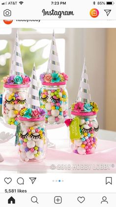 a group of jars filled with candy on top of a table