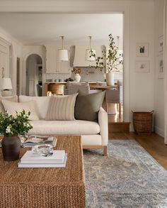 a living room filled with furniture and a rug on top of a wooden coffee table