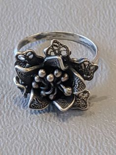 Vintage Sterling Silver Flower Ring Solid Sterling Silver flower ring with nice detailing. Ring fully hallmarked and will arrive gift boxed. * HALLMARKS 925 on back of flower. * MEASUREMENTS ring size 5 1/2, face of ring measures 17mm at widest part. * CONDITION In very good to excellent condition. Please use all pictures as part of item's description. * MATERIALS Sterling Silver. Vintage Flower Shaped Ring As Gift, Silver Filigree Flower Ring As Gift, Silver Filigree Flower Ring Gift, Vintage Flower-shaped Ring As A Gift, Vintage Style Flower Shaped Rings For Gift, Vintage Flower Shape Rings For Gift, Formal Hallmarked Flower Ring, Hallmarked Silver Flower Ring, Elegant Flower Shaped Ring Stamped 925