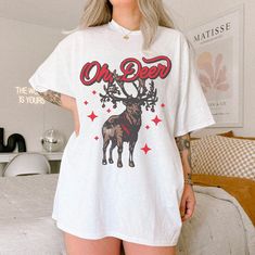 Oh Deer Tee UNISEX Vintage Christmas Retro Graphic Tee Reindeer T Shirt North Pole Shirt Secret Santa Gifts For Her Him Trendy Festive Shirt  Shop all The June Kind - https://www.etsy.com/ca/shop/TheJuneKind? ---------- Please read before placing your order -------------- 1. This apparel is GENDER NEUTRAL / UNISEX. The relaxed fit is flattering for all bodies. 2. Refer SIZE CHART for measurements. Upsize for oversized looks. 3. This is a Gildan thick 100% cotton unisex tee. Expect some distressi Pole Nord, Festival Shirts, Retro Graphic Tees, She & Him, Oh Deer, North Pole, Secret Santa Gifts, Secret Santa, Retro Christmas