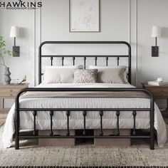 a black metal bed frame with white sheets and pillows on top of it in a bedroom