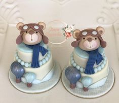 two teddy bears sitting on top of cakes