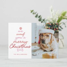 a christmas card with a dog wearing a santa hat