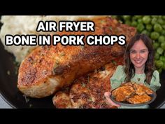 a woman holding a plate full of food with the words air fryer bone in pork chops