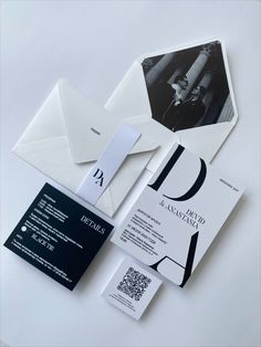 an assortment of business cards and envelopes on a white surface with the letter d