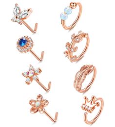 six pairs of rings with different shapes and sizes, including an arrow, flower, leaf, and crystal stones