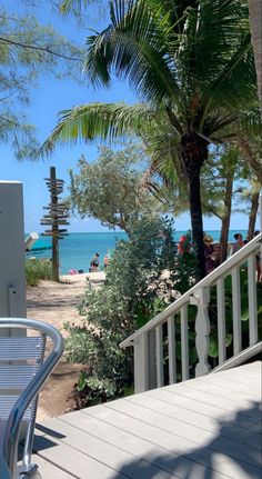 there is a view of the beach and ocean from this deck area in front of the house