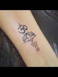 a woman's arm with a tattoo on it that reads 50 and is decorated with flowers