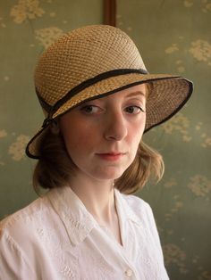 "An authentic antique woven cloche from the late 1920s or 30s era. Originally acquired by a European hat shop that closed in the 1930s. Made from a light colored woven straw with a simple yet elegant black wax coated ribbon and buckle. Only minor signs of age from storage, never been previously used. Centimeter measurements written on the inside of the crown by the hat maker. material : straw, silk? ribbon color : black, light beige condition : little to no wear, has never been used size : pleas Vintage Cloche Hat For Kentucky Derby, Vintage Fedora Sun Hat For Kentucky Derby, Vintage Cloche Hat For Kentucky Derby With Short Brim, Vintage Kentucky Derby Cloche Hat With Short Brim, Vintage Straw Hat With Short Brim For Church, Vintage Straw Hat With Short Brim, Flapper Style Short Brim Cloche Hat For Kentucky Derby, Vintage Fashion Hats For Kentucky Derby With Short Brim, Vintage Style Short Brim Hat For Kentucky Derby