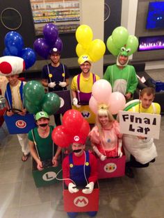 a group of people dressed up as mario and luigi with balloons in the shape of characters