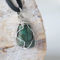 Live bold with compassion and truth to your heart with this emerald gemstone necklace. Handcrafted with care, the detailed sterling silver design offsets a polished raw emerald. Each emerald necklace is handcrafted with care and a deep respect for the crystal. You can wear the raw stone pendant on either side due to the pendant’s reversible design. Each stone ranges in size and shape creating a unique pendant for you that won’t be duplicated.- The stone is 40-55 carat real, authentic, naturally Emerald Necklace With Natural Stones As A Gift, Emerald Necklace For Gift, Gift Emerald Necklace With Natural Stones, Artisan Emerald Jewelry For Gifts, Silver Emerald Necklace As A Gift, Handmade Sterling Silver Emerald Necklace As Gift, Spiritual Emerald Necklace For May Birthstone, Silver Emerald Pendant Necklace As Gift, Spiritual Emerald Necklace As Gift