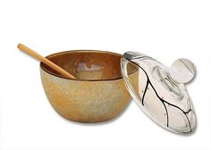 a glass bowl with a wooden spoon in it