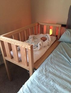 a baby is sleeping in his crib next to the bed