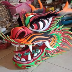 an elaborate dragon mask is on display in a shop