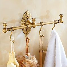 a towel rack with two towels hanging from it's sides and hooks on the wall