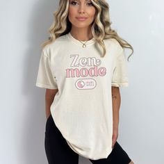 a woman wearing a white t - shirt with the words'zen mode on it