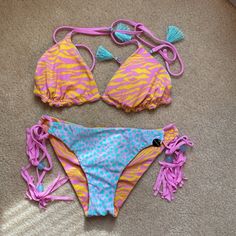 Nwot (“Reversible” Tag Is Still Attached To The Bottoms). This Is My Absolute Most Beautiful Bikini, But I Have Never Worn It. Gorgeous Animal Print Blue/Pink And Pink/Orange. It Can Be Worn Many Different Ways. Beautiful Attention To Detail And So Much Attention To Detail With The Braided Adjustable Straps On The Bottom, Tassels And Blue Decorative Ball. Tassels On The Top As Well. Ruching On The Back Of The Bottoms. Non-Removable Pads. Please Note The Top Is Large, The Bottoms Are Small! There Playful Pink Triangle Top Swimwear, Victoria's Secret Tie-side Swimwear For Beach Season, Victoria's Secret Triangle Top Swimwear For Pool, Fun Pink Triangle Top Swimwear, Victoria's Secret Tie-side Swimwear, Fun Pink Stretch Swimwear, Fun Pink Swimwear For Festival, Victoria's Secret Multicolor Swimwear For Sunbathing, Victoria's Secret Multicolor Swimwear For Poolside