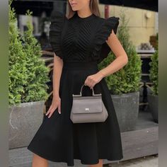 Embrace Timeless Sophistication With This Stunning Black Midi Dress, Featuring Striking Ruffle Sleeves And A Beautifully Pleated Bodice For A Touch Of Modern Elegance. The Fit-And-Flare Silhouette Enhances Your Figure, While The Soft Fabric Provides Both Comfort And Style. Perfect For Both Formal Occasions And Chic Day Outings, This Dress Is A Versatile Addition To Any Wardrobe. Pair It With Your Favorite Accessories For A Polished, Refined Look. Style: Ruffle Sleeve, Fit-And-Flare Material: Hig Pleated Bodice, Black Midi, Sleeve Midi Dress, Midi Dress With Sleeves, Ruffle Sleeves, Black Ruffle, Black Fits, Modern Elegance, Black Midi Dress