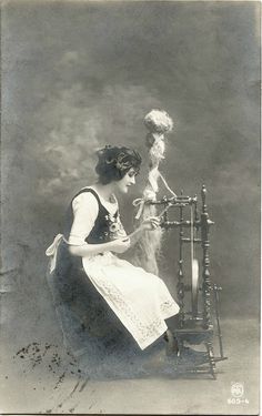 an old fashioned photo of a woman sewing on a machine with a doll in the background