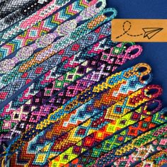 colorful bracelets are on display in front of a blue background with an orange tag