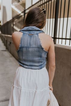 The Dallas Denim Ruched Tank, a contemporary blend of style and comfort that adds a touch of sophistication to your wardrobe. Crafted from medium denim lightweight fabric, this tank top offers both durability and breathability for all-day wear. The standout feature of the Dallas tank is its front ruched detail, which adds texture and visual interest to the ensemble while flattering the figure. This subtle yet stylish embellishment elevates the tank's overall aesthetic, making it a versatile piec Trendy Medium Wash Vest Top, Summer Medium Wash Denim Vest Top, Medium Wash Denim Vest Top For Summer, Medium Wash Sleeveless Vest Top, Stretch Denim Sleeveless Tank Top, Light Wash Sleeveless Denim Vest For Day Out, Summer Stretch Denim Blue Denim Vest, Medium Wash Denim Vest For Summer Day Out, Denim Vest Top For Summer