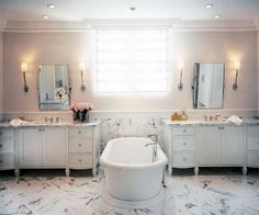 a bathroom with marble floors and white fixtures