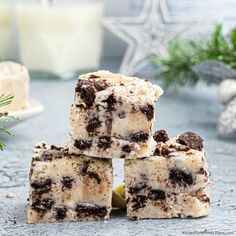 four pieces of cake sitting on top of a table next to candles and christmas decorations