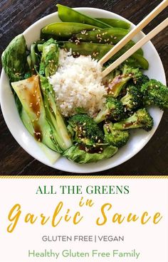 a white plate topped with broccoli and rice next to chopsticks on top of a wooden table