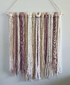 a wall hanging made out of yarn and rope