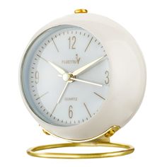 a white and gold alarm clock on a stand