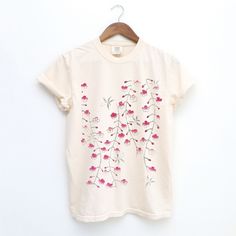 Experience the elegance of Japanese art with our Comfort Colors cotton t-shirt, featuring a stunning print of "Cherry Blossom" from Shin Bijutsukai, a renowned Japanese art magazine from the early 1900s. The magazine featured a variety of traditional Japanese art forms, including designs, patterns, and illustrations. It is known for its high-quality woodblock prints, which often depicted nature, including themes like cherry blossoms. This soft, high-quality tee combines timeless beauty with all-day comfort. Perfect for art lovers and those who appreciate unique, stylish apparel. The soft-washed, garment-dyed fabric brings extra coziness to your wardrobe while the relaxed fit makes it an excellent daily choice. The double-needle stitching throughout the tee makes it highly durable while the Kawaii Shirts, Traditional Japanese Art, Japanese Streetwear, Japanese Cherry Blossom, Floral Fashion, Retro Art, Art Clothes, Japanese Traditional, Cherry Blossom