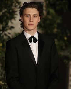 a young man in a tuxedo and bow tie