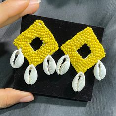 Handcrafted Yellow Cowrie shell drop earrings . Perfect to wear for Beach or vacations.  Best thing is that it can be worn for long hours as it is lightweight. 100% Handmade Closure- pushback Back of the earring is white leather. Custom colors available Each piece is handmade with love.  Free shipping to Canada and USA. It will be shipped via regular non trackable Canada post parcel within 2 days after placing the order. Estimate shipping times for Canada is 4-6 days. USA- 1-2 weeks. Thankyou fo Cowrie Shell Earrings, Paper Quilling For Beginners, Diy Jewellery Designs, Beach Earrings, Love Free, Long Hours, Cowrie Shell, Canada Post, Shell Earrings