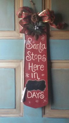 a door hanger that says santa stops here in days