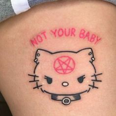 a hello kitty tattoo with the words not your baby written on it's thigh