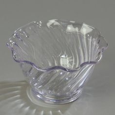 a clear glass bowl sitting on top of a table