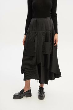 Discover the versatility of our Asymmetric A-Line Midi Skirt in timeless black. This skirt features layered pleated sections and unique detachable pockets, offering both style and functionality. With the option to change the silhouette, you can create a variety of distinct looks. From casual to sophisticated, this black midi skirt is a fashion-forward addition to your wardrobe, ready to adapt to your individual style.This item is Made-to-Order. Please allow us from 2 to 5 working days to make yo Black Asymmetrical Skirt With Folds, Black Long Skirt With Folds, Black Long Skirt With Side Pockets, Black Long Skirt With Accordion Pleats, Black Accordion Pleats Skirt, Black Cargo Skirt For Work, Black Midi Skirt With Side Pockets, Black Tiered Skirt With Pockets, Chic Black Cargo Skirt With Side Pockets