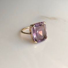 A 9 carat yellow gold Amethyst ring. This beautiful piece displays a gorgeous purple stone in the clutches of a striking gold setting. CONDITION: Minor wear can be seen on face. Condition consistent with age and use. Please see photos for more detail. STONE SIZE: 13mm x 15mm BAND WIDTH: 1mm SETTING HEIGHT: 5mm RING SIZE: UK: M | US: 6 1/4 WEIGHT: 4.2 grams Luxury Yellow Gold Amethyst Ring, Luxury Vintage Amethyst Ring, Luxury Yellow Gold Amethyst Ring With Accent Stones, Luxury Purple Amethyst Ring, Rectangular Shape, Luxury Purple Amethyst Rectangular Ring, Luxury Purple Rectangular Amethyst Ring, Classic Large Stone Amethyst Ring For Formal Events, Classic Formal Amethyst Ring With Large Stone, Luxury Rectangular Amethyst Ring